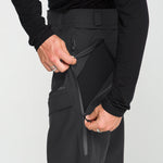 Black snow pants with thigh cargo pocket, belt loops, and adjustable waistband tabs