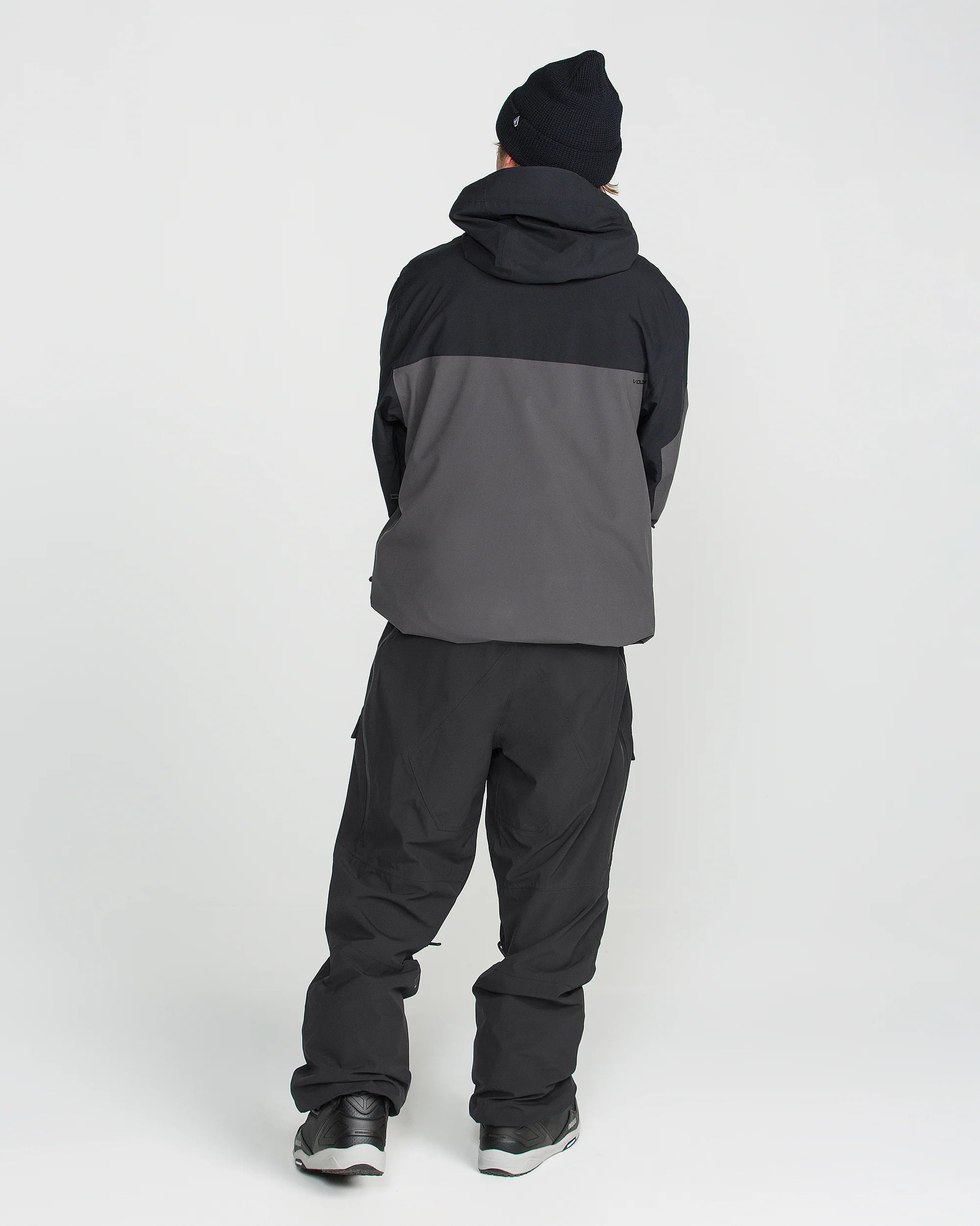 Black snowboard pants with ankle cuffs and cargo-style utility pockets.