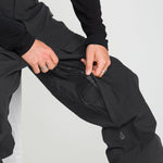 Black stretch ski pants with adjustable waistband and side pocket zipper detail