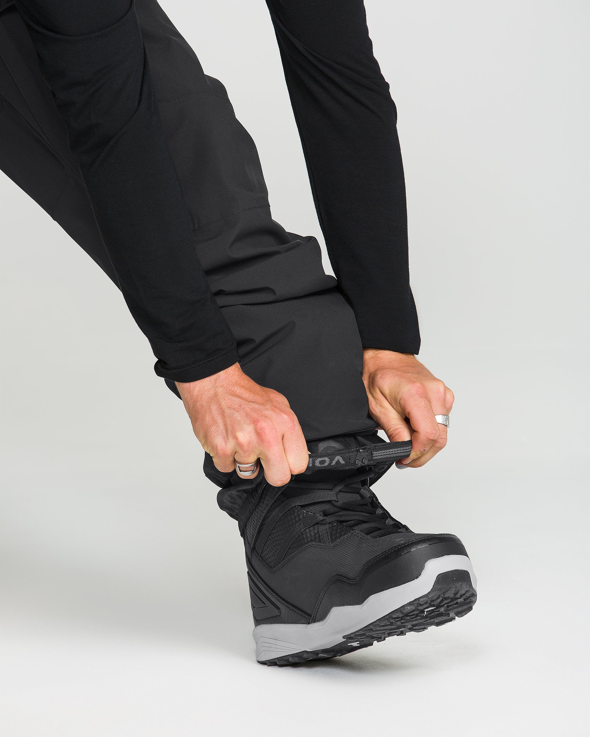 Black snowboard pants with zip cuff at the ankle and secure boot fit.