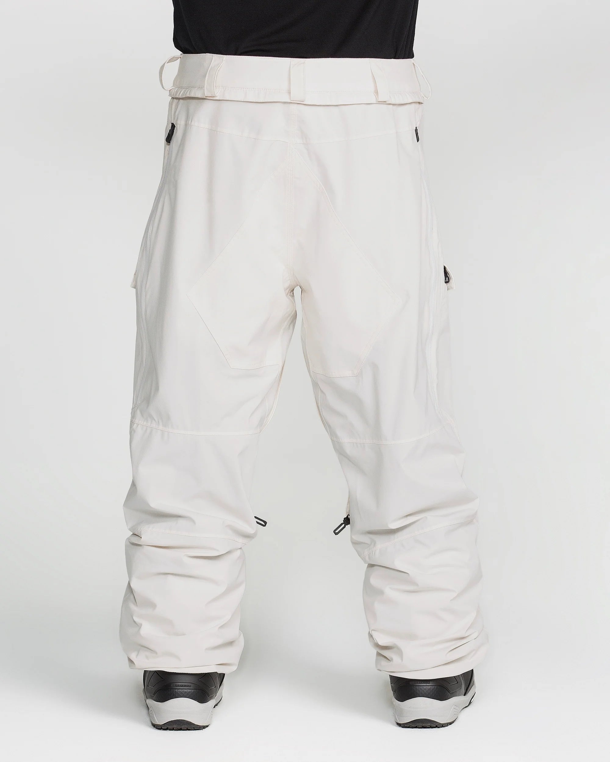 Off-white snowboard pants from the back with knee seams and elasticized cuffs.