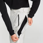 Off-white snowboard pants with front zip leg pocket and brushed interior lining.