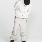 Off-white stretch snow pants with multiple cargo pockets, belt loops, and cuffed hems