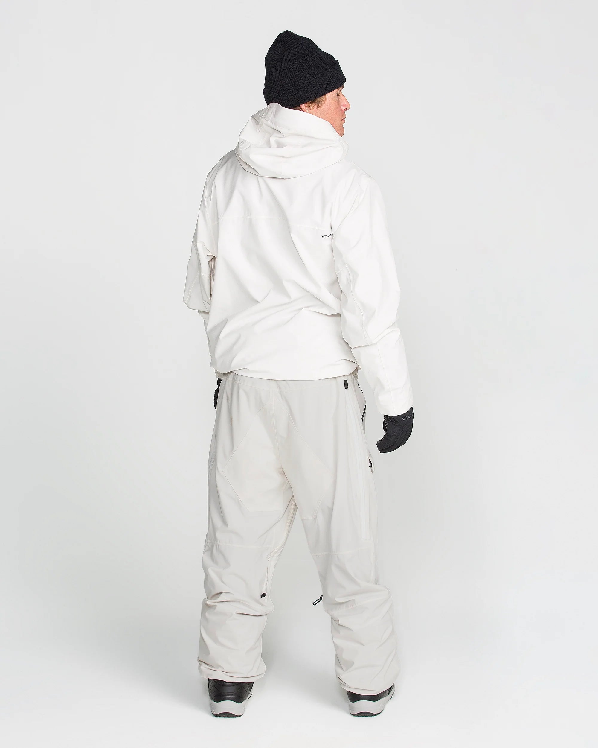 Off-white ski pants with belt loops, cargo pockets, and elastic boot-cuff hems