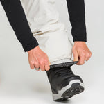 Off-white snowboard pants with secure ankle cuff and reinforced hem.