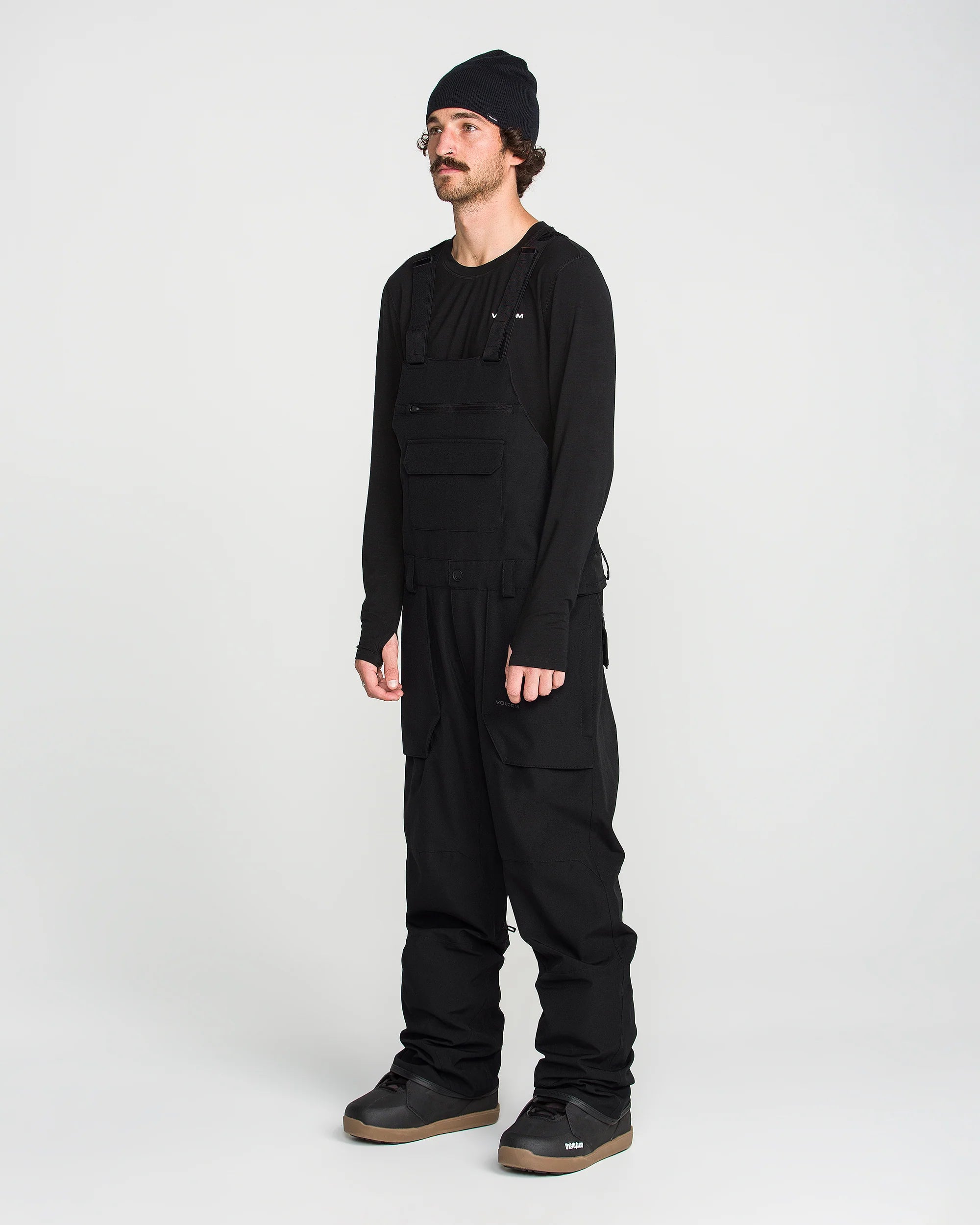Black bib snow overall front view with chest pockets and side cargo pockets