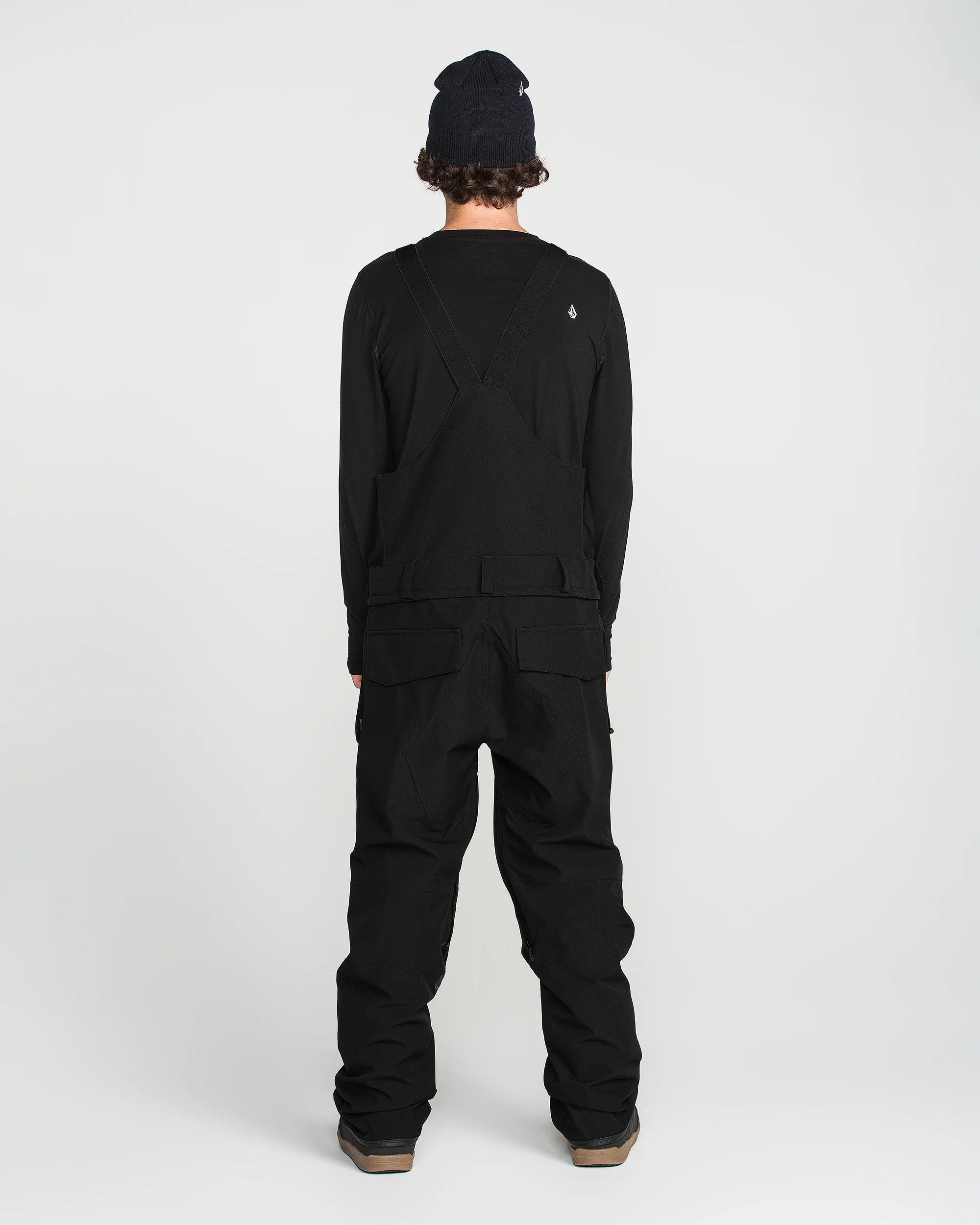 Black bib snow overall rear view with leg cargo pockets and adjustable straps
