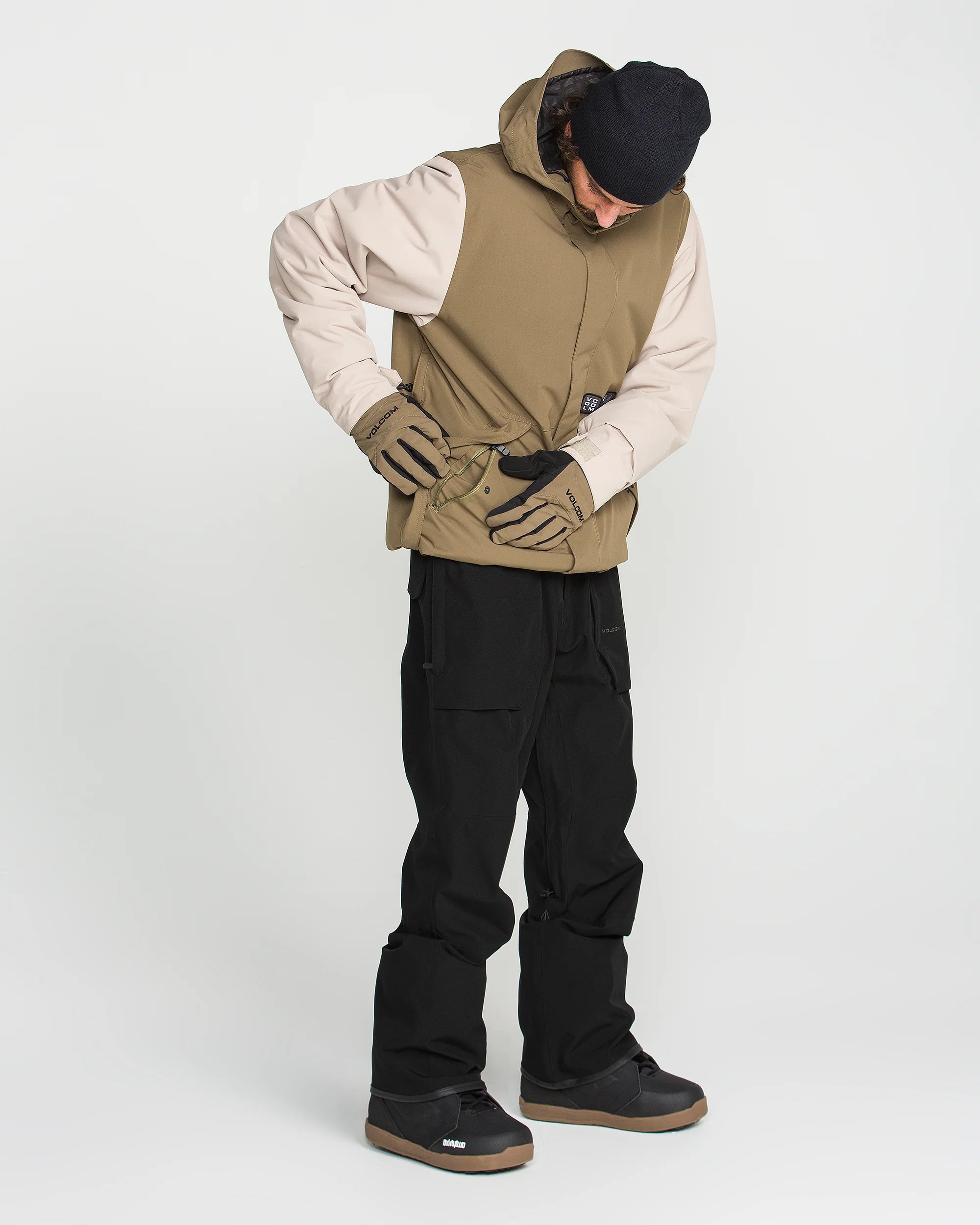 Teak bib snow overalls with adjustable straps, black legs, and cargo pockets