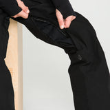 Black bib snow overall leg with zippered pocket access and logo patch