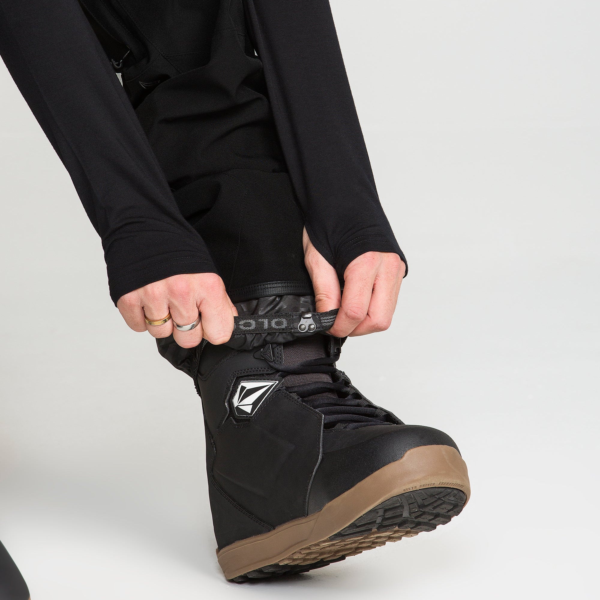 Black bib snow overall lower leg with boot lace-through strap and gaiter