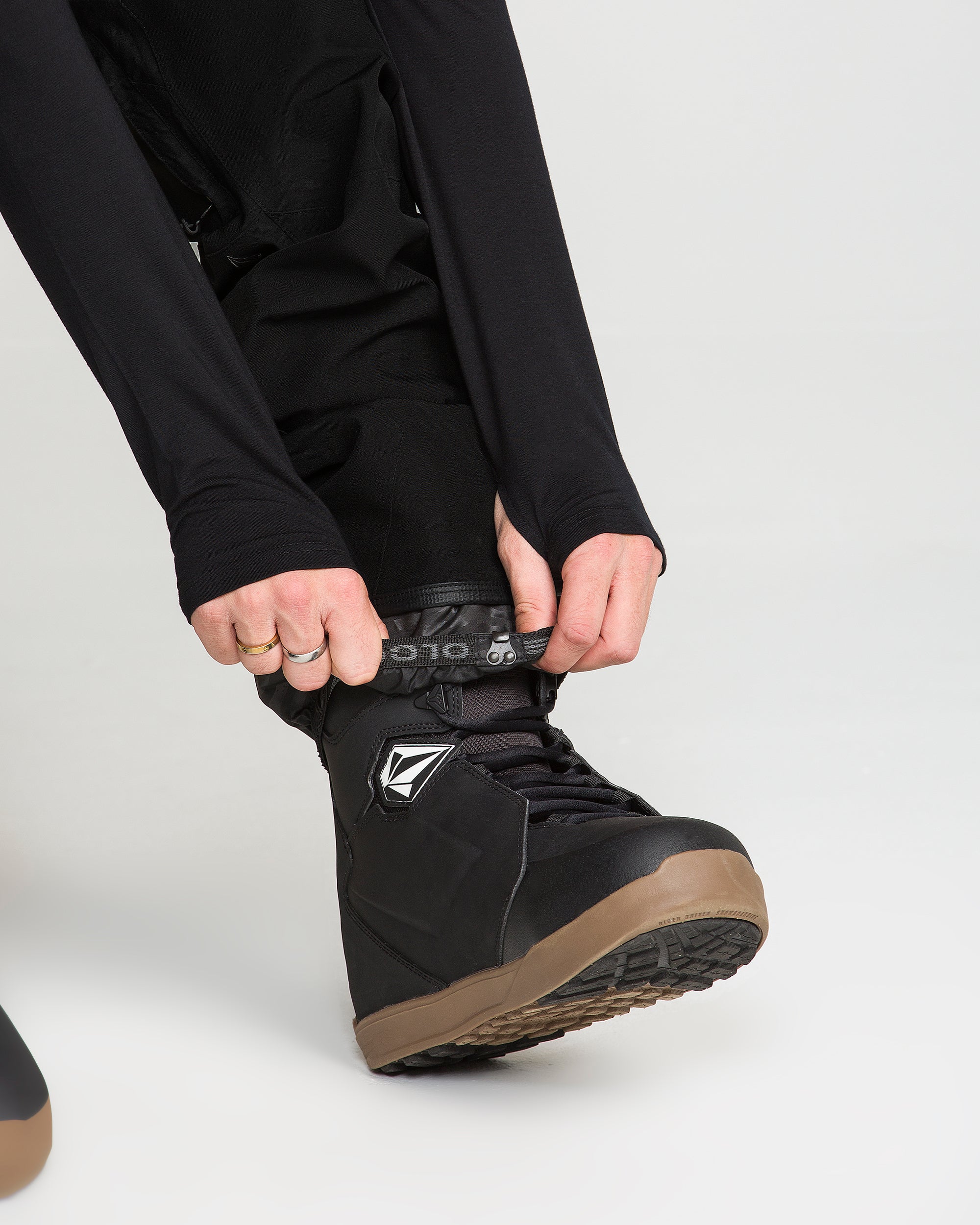 Black bib snow overall lower leg with boot lace-through strap and gaiter