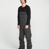 Black bib overall on model with front bib pocket and adjustable strap hardware