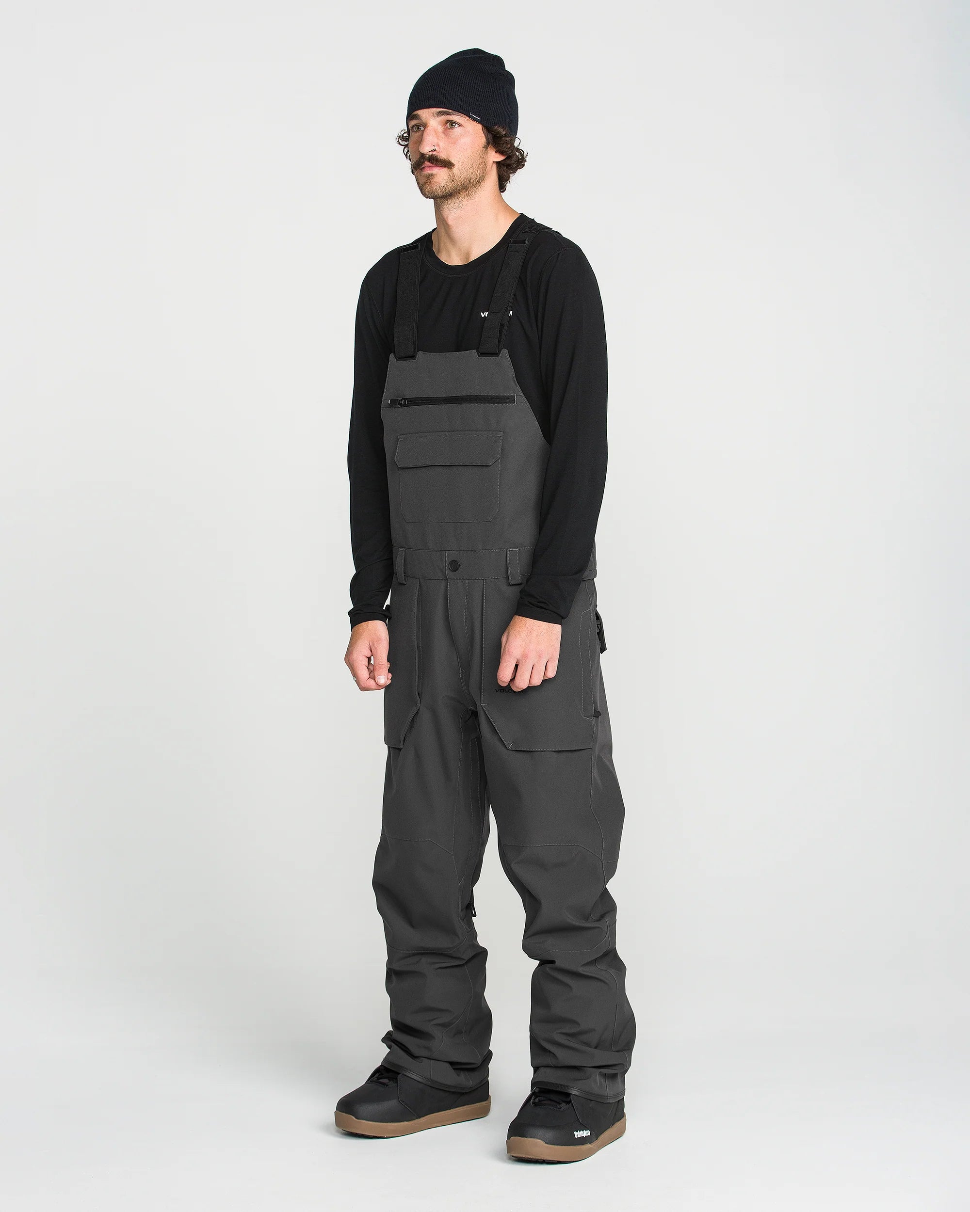 Black bib overall on model with front bib pocket and adjustable strap hardware
