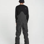 Black bib overall back panel with center seam and cargo pocket stitching