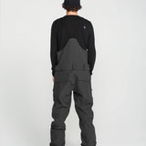 Black bib overall back panel with center seam and cargo pocket stitching