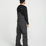 Black bib overall back view with shoulder straps and wide leg fit