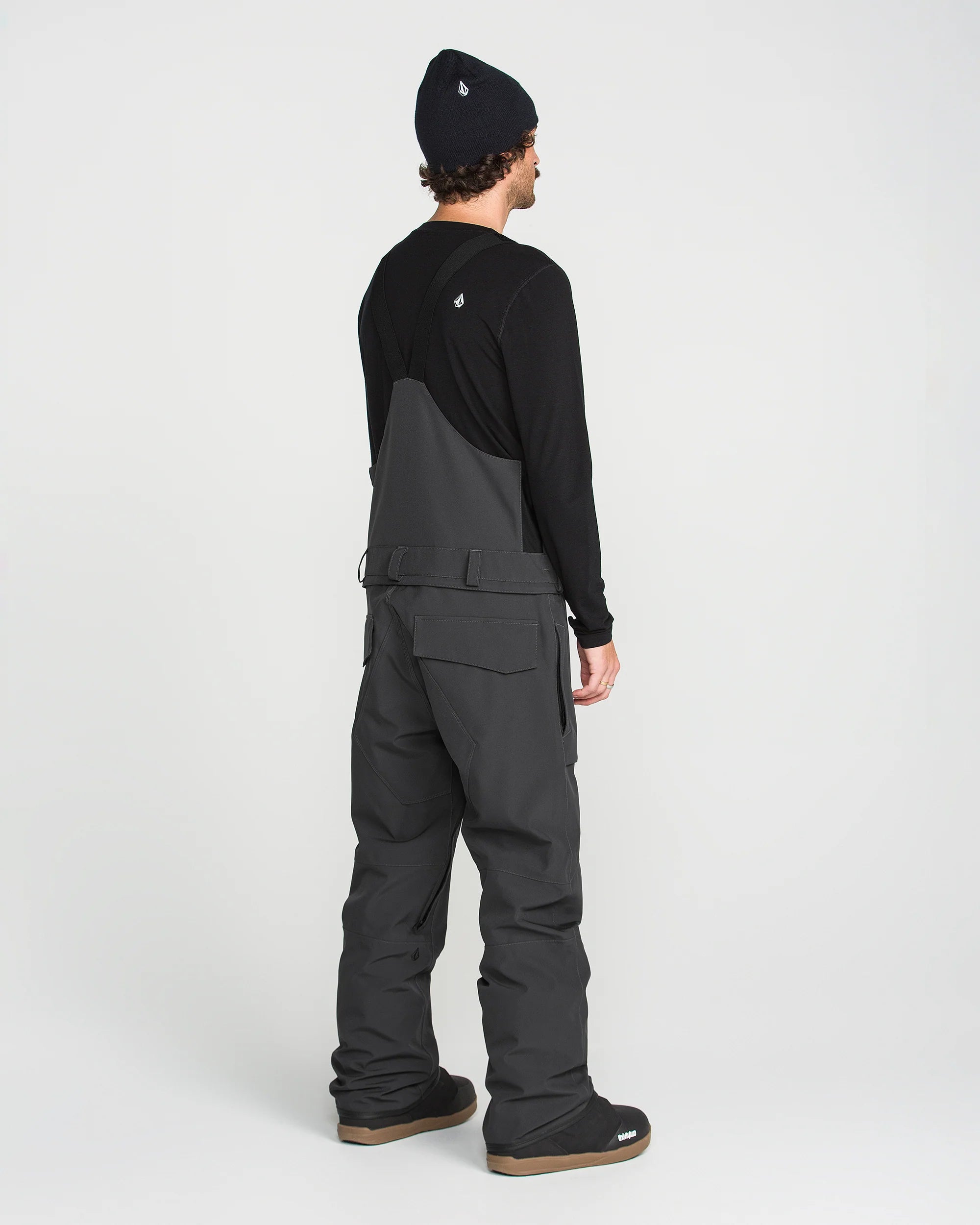 Black bib overall back view with shoulder straps and wide leg fit