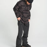 Black bib overall on model, side view with cargo pocket details and ankle cuffs