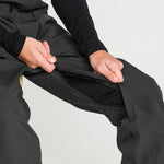Black bib overall with reinforced inner panel and snap-button fly at front