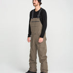 Brown bib overall worn with adjustable straps and front cargo pockets
