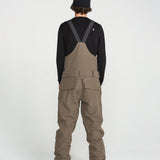 Brown bib overall back view with V-shaped strap panel and cargo pockets
