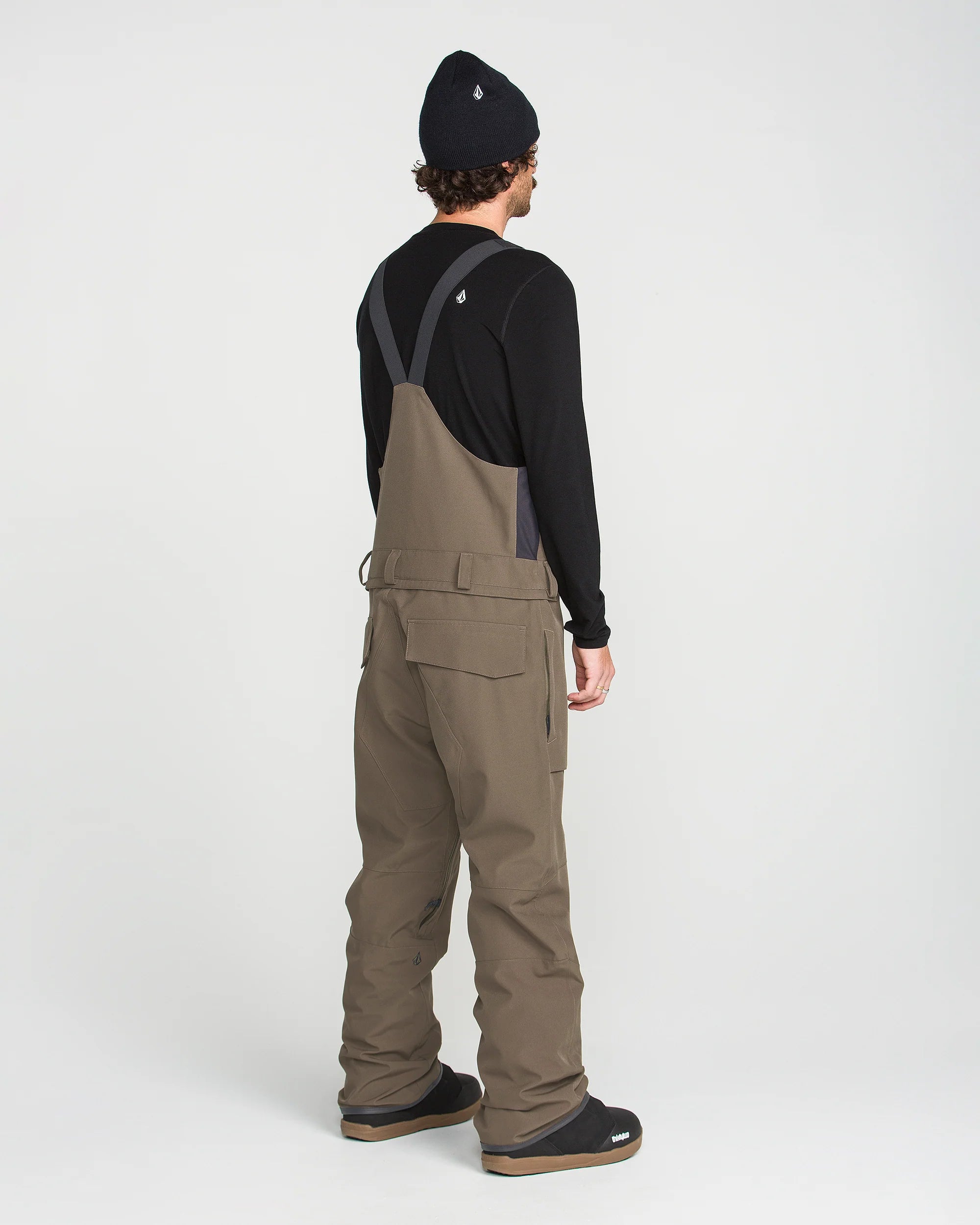 Brown bib overall back view with adjustable shoulder straps and cargo pockets