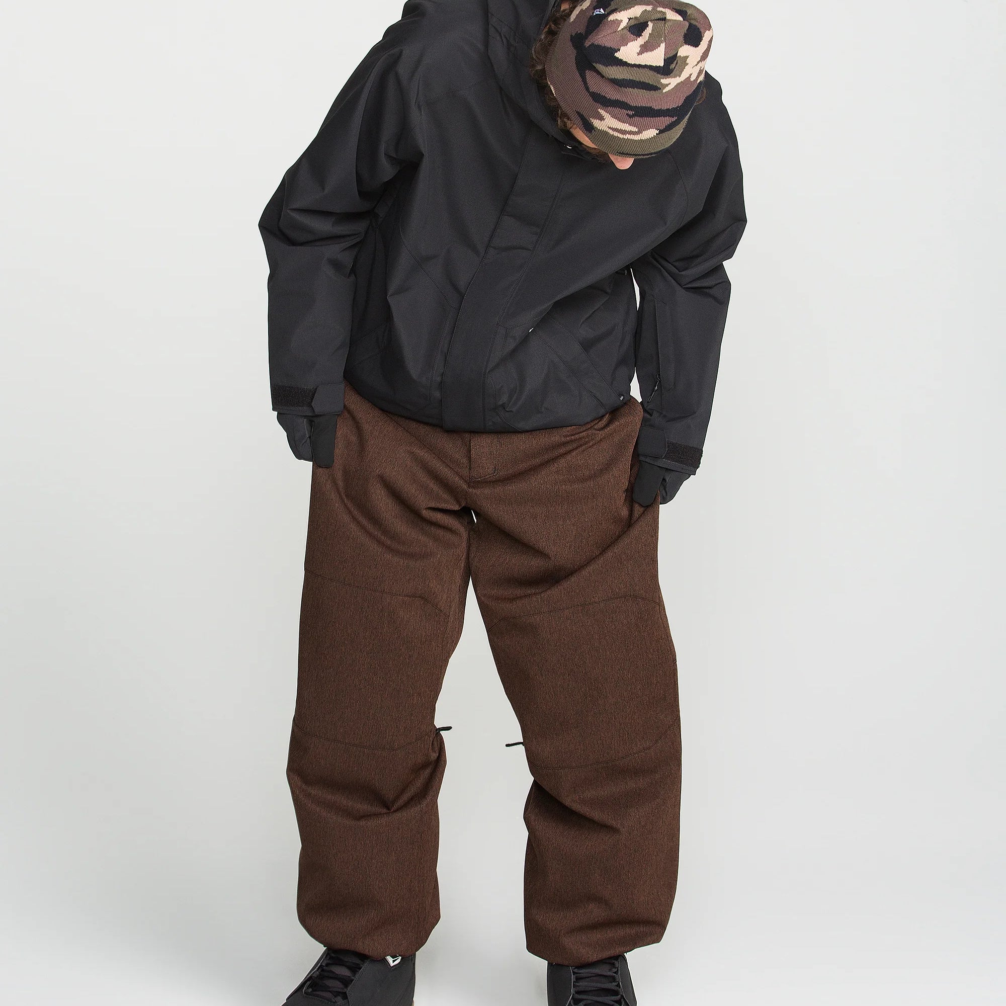 Brown snow pants with two front pockets and relaxed straight legs