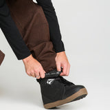Close-up of brown snow pants fabric with front pocket and cinch detail