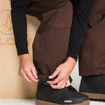 Brown snow pants with front pocket and adjustable waistband detail