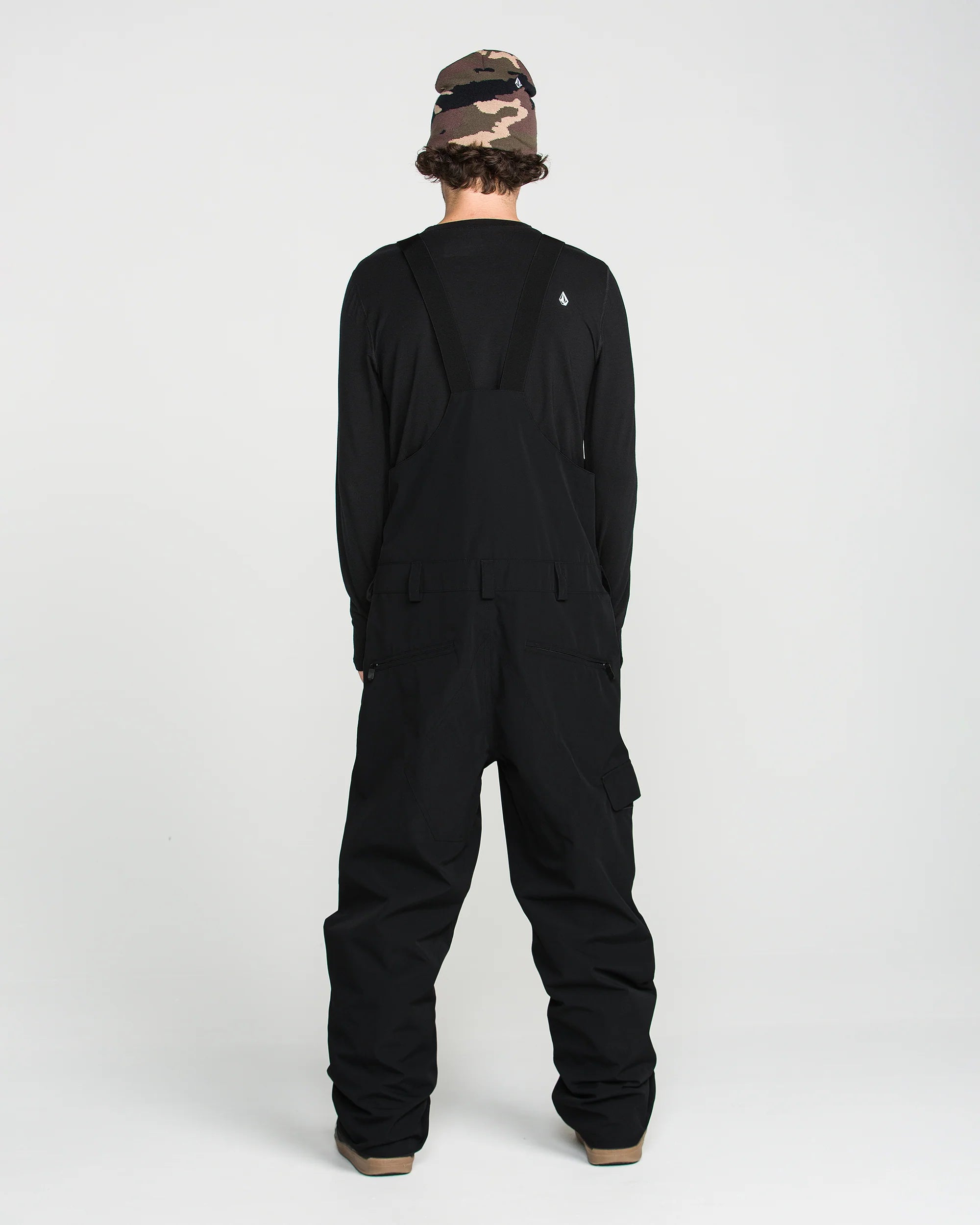 Black bib overall back view with bib seam details and leg cargo pocket panels