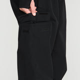 Black bib overall with front utility pocket panels and stitched seams
