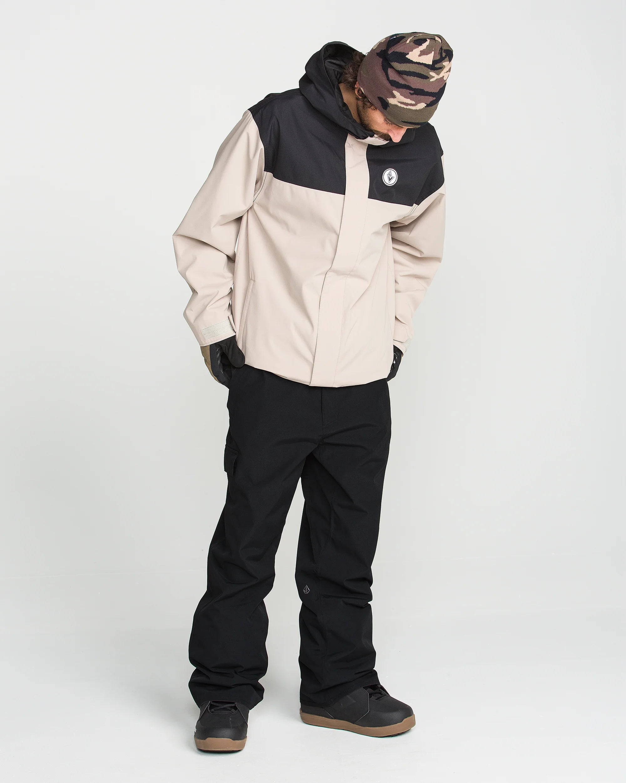 Black bib overall with front bib panel, side pockets, and adjustable straps