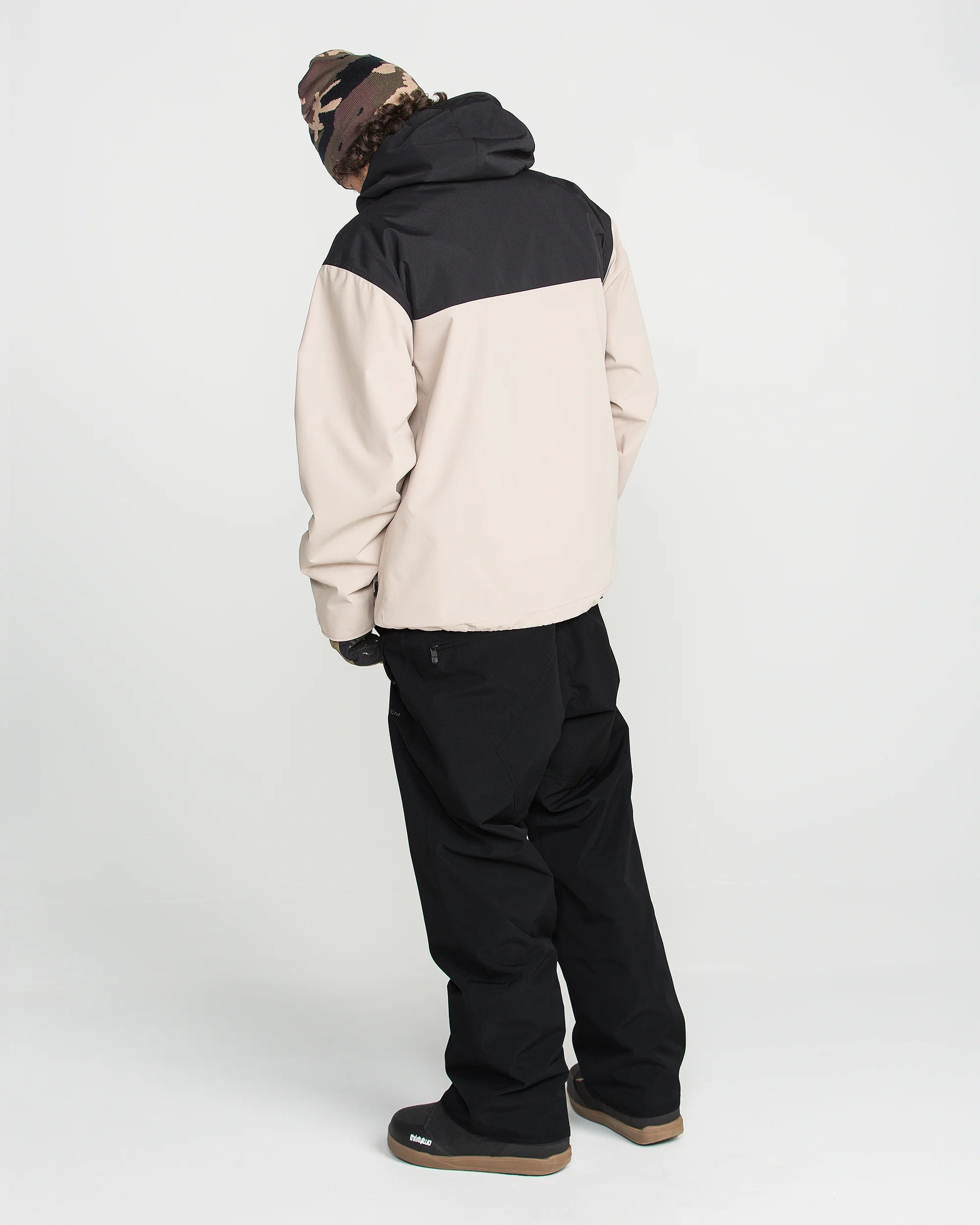 Black bib overall worn with side cargo pockets and adjustable strap buckles