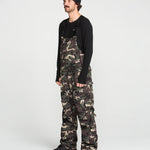 Camo bib overalls front worn full length with black long-sleeve top underneath
