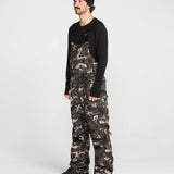 Camo bib overalls front worn full length with black long-sleeve top underneath