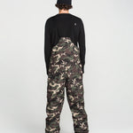 Back view of camouflage bib overalls with black rear yoke and full-length legs