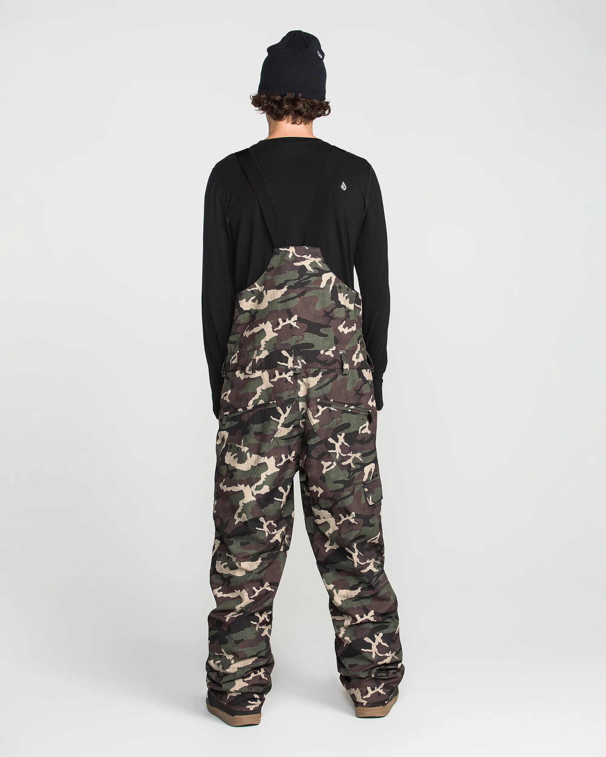 Back view of camouflage bib overalls with black rear yoke and full-length legs