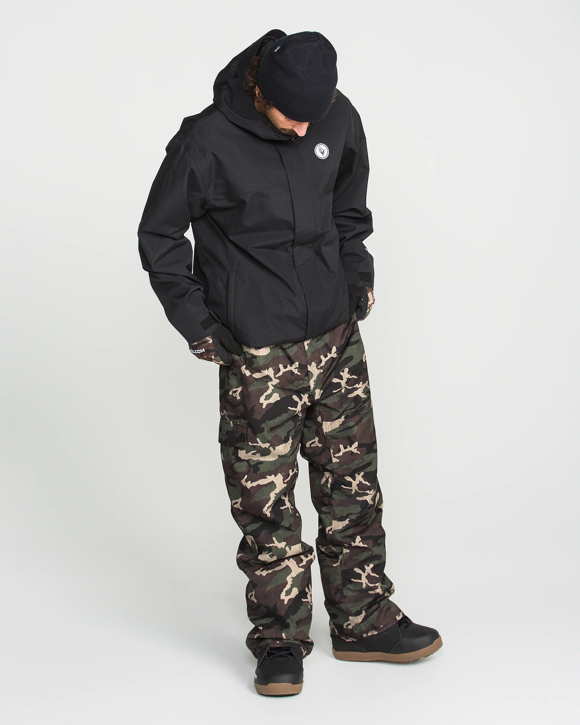 Camouflage bib overalls with black back-facing hood and full-length pant legs