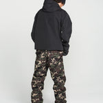 Camouflage bib overalls shown from back with black hooded jacket and boots