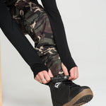 Camo bib overalls leg cuffs with black side panel and tan outsole boots