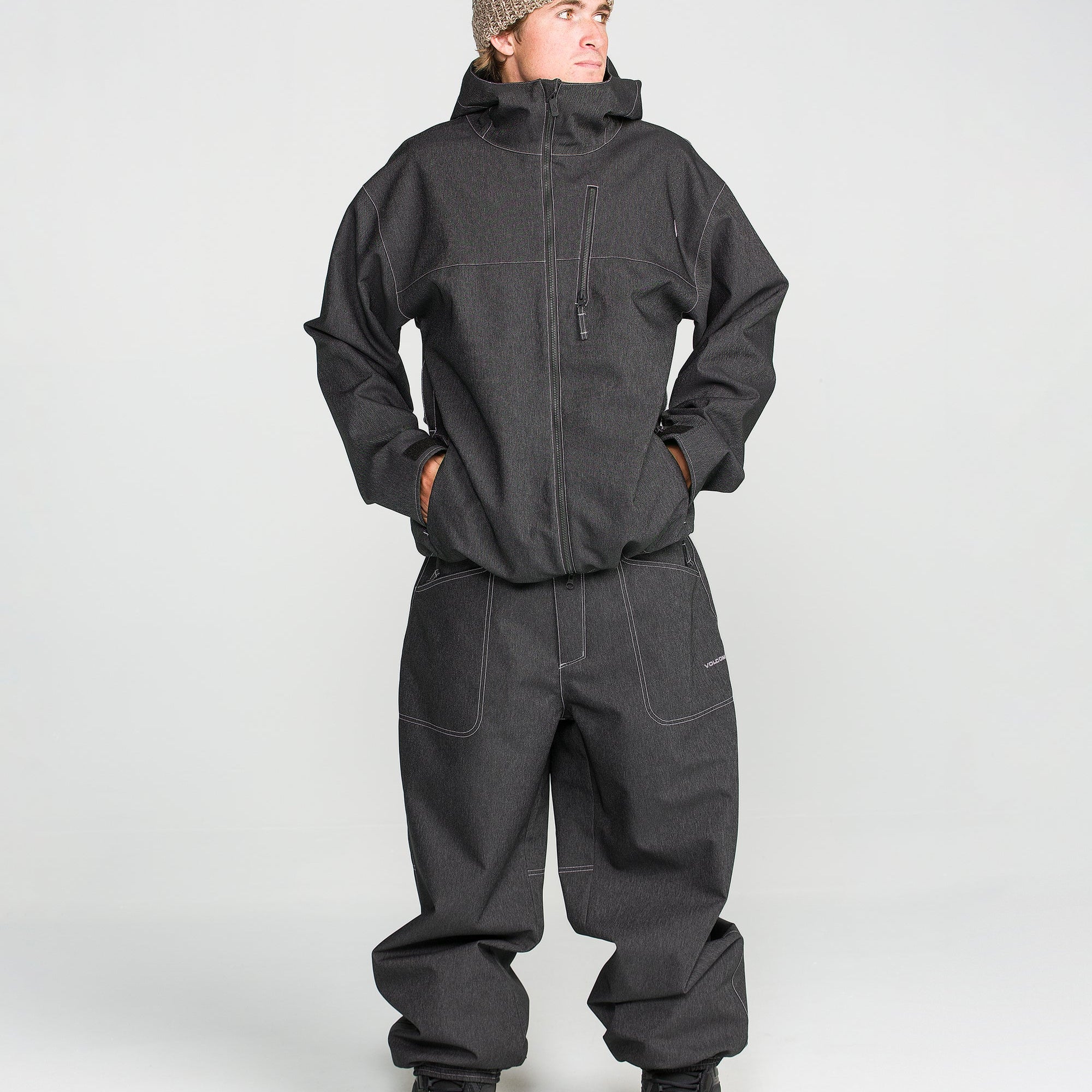 Black snow pants with adjustable cuffs, belt loops, and front slash pockets