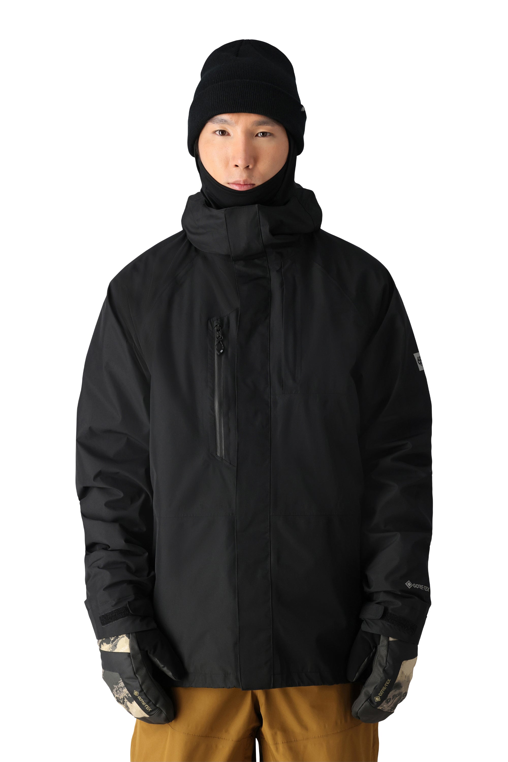 The 686 Gore-Tex Core Shell Jacket has a black exterior with a prominent white logo on the left sleeve.