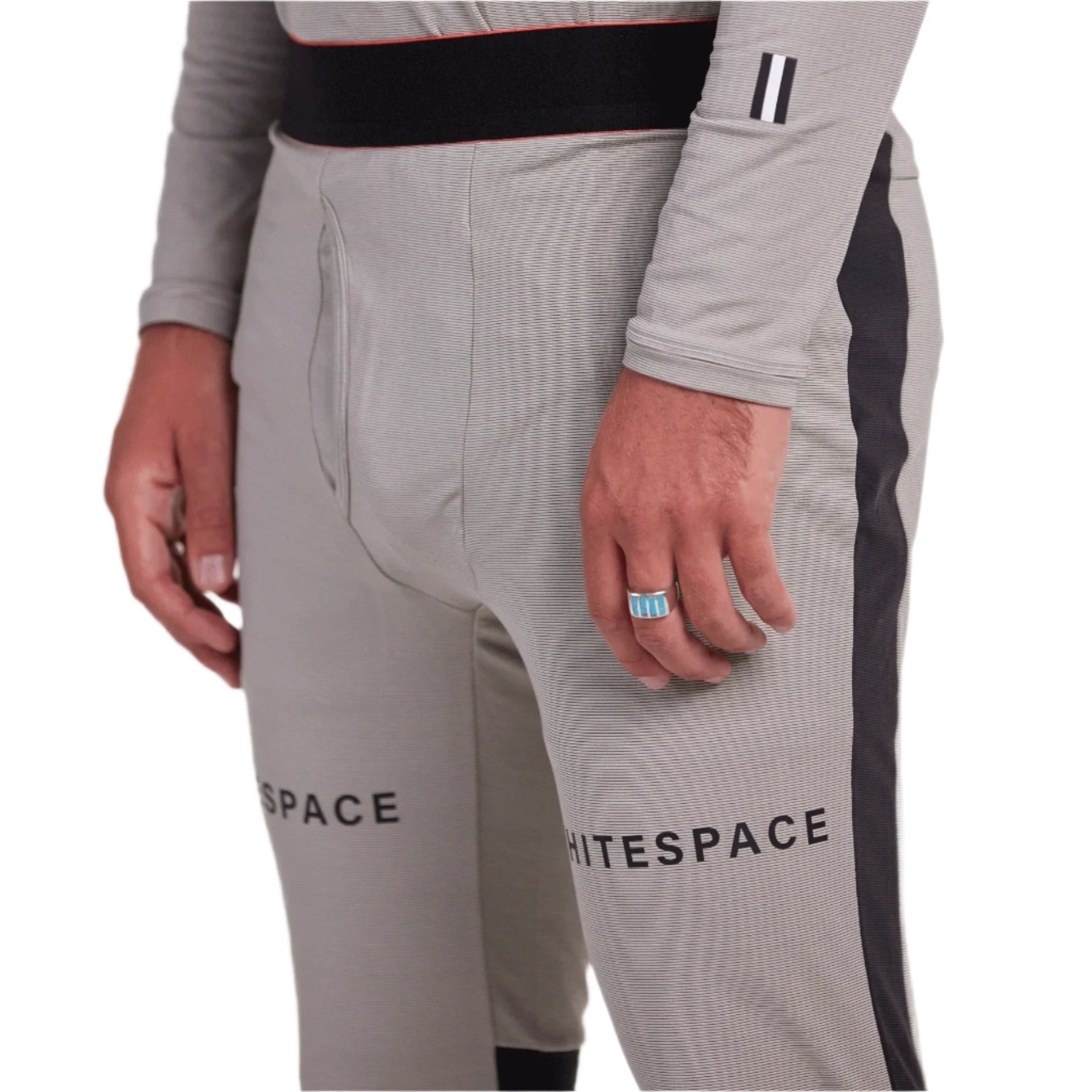 Whitespace Graphene Midweight Base Layer Bottom 2024 - A pair of light gray base layer bottoms with a subtle horizontal stripe pattern and black trim along the waistband.
