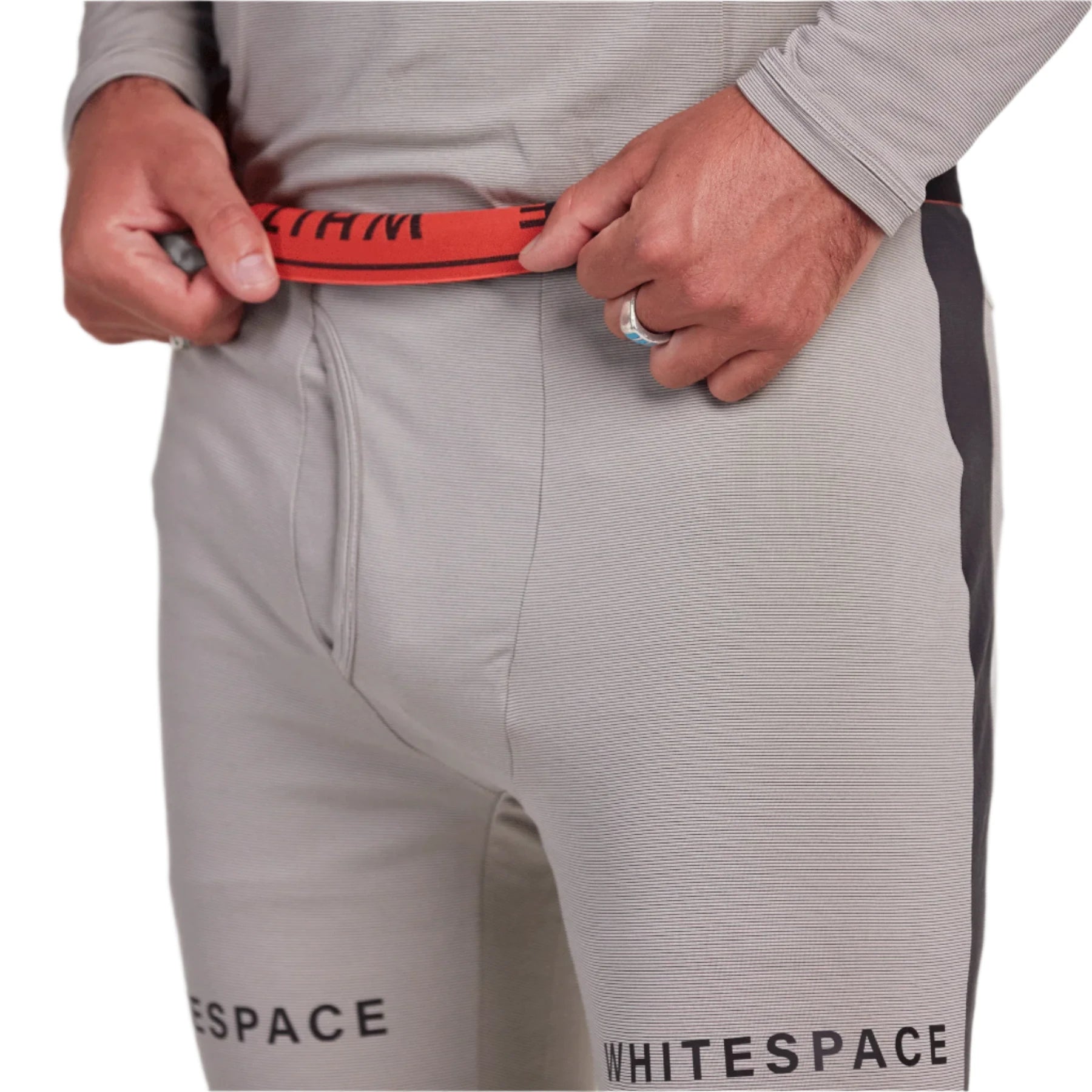 Whitespace Graphene Midweight Base Layer Bottom 2024 - A pair of light gray base layer bottoms with a subtle horizontal rib pattern and black lettering that reads "Whitespace" on the left leg.