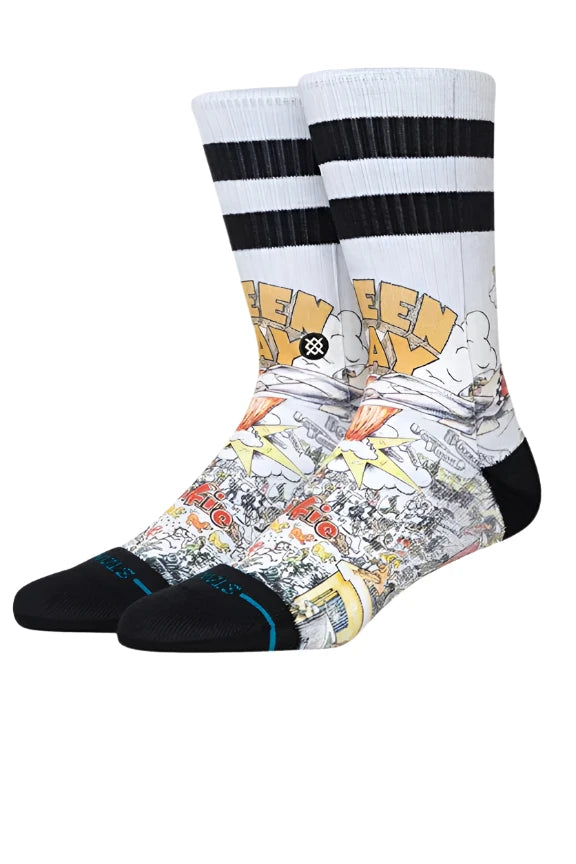 Stance x Green Day Basket Case Crew Sock 2024 - A pair of crew socks with a black and white striped pattern at the top, featuring a yellow "GREEN DAY" logo in bubble letters on the front.