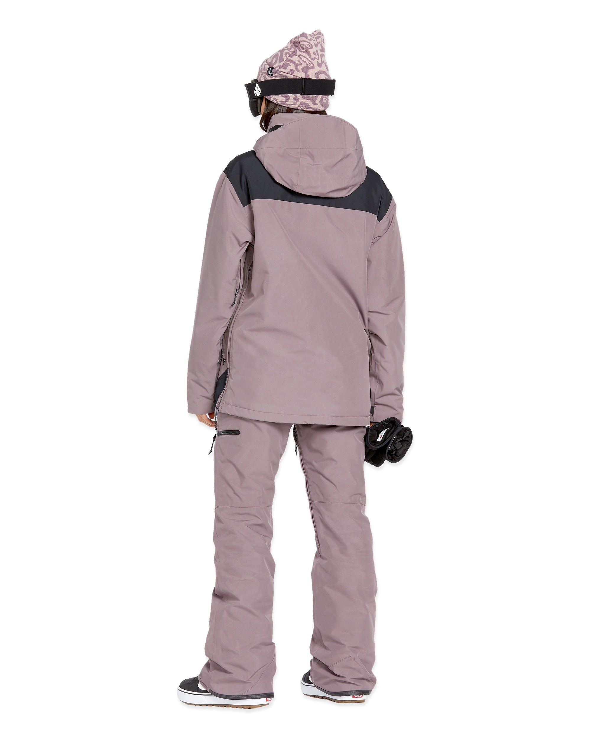 Volcom Women's Fern Insulated GORE-TEX Pullover - A woman wearing a dusty rose-colored jacket with black shoulder accents and a matching beanie, standing against a white background.