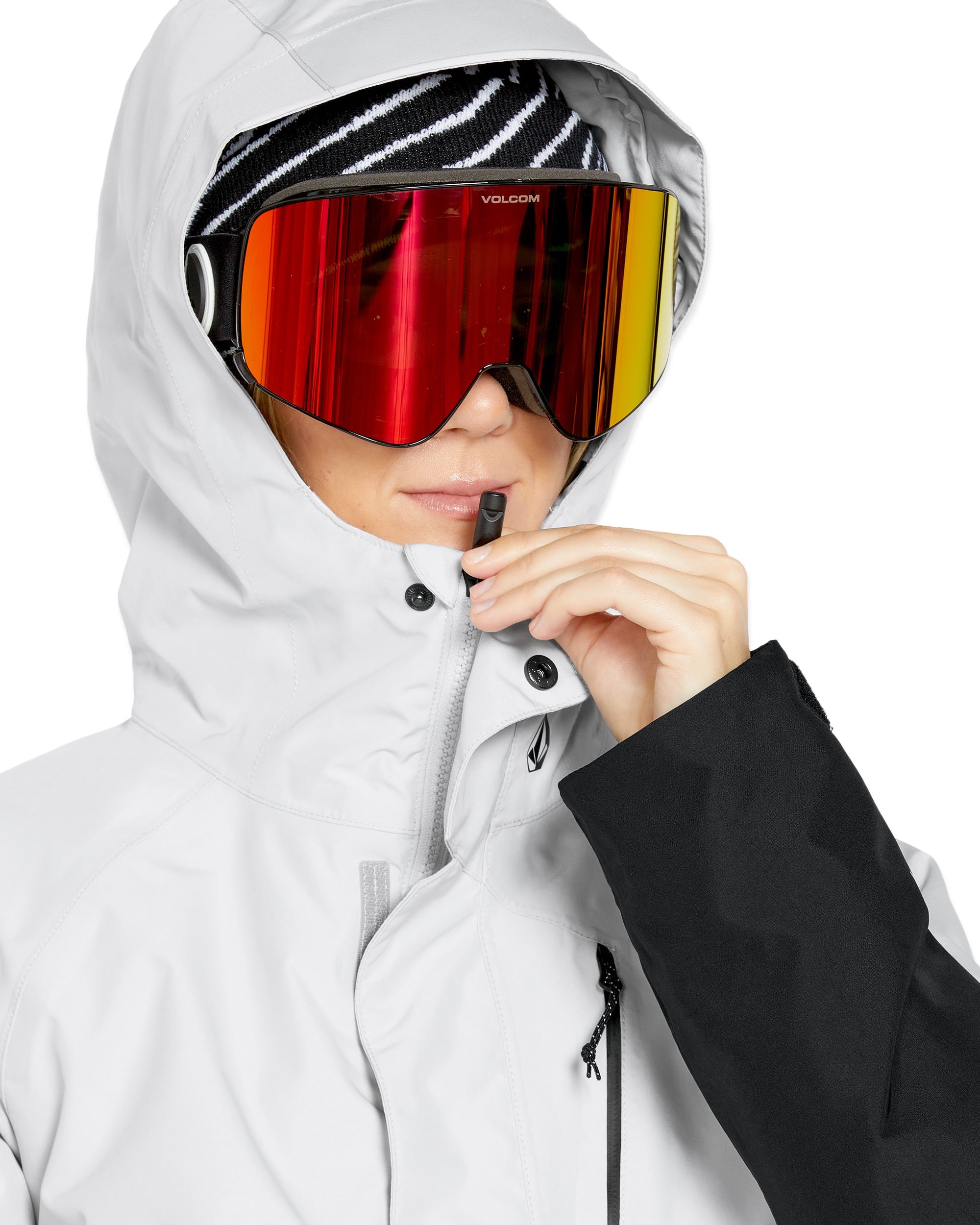 Volcom Women's V.Co Aris Insulated GORE-TEX Jacket - A black and white striped beanie is worn under a hood with a shiny silver lining.
