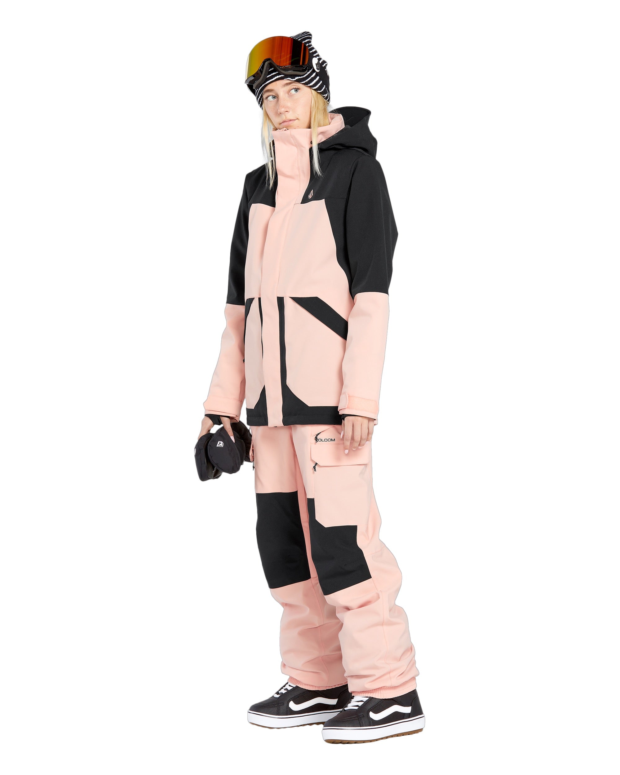 Volcom Women's Creston 3D Stretch Bib Overall - A pink and black bib overall with a geometric pattern on the front, featuring a zippered fly and adjustable straps.