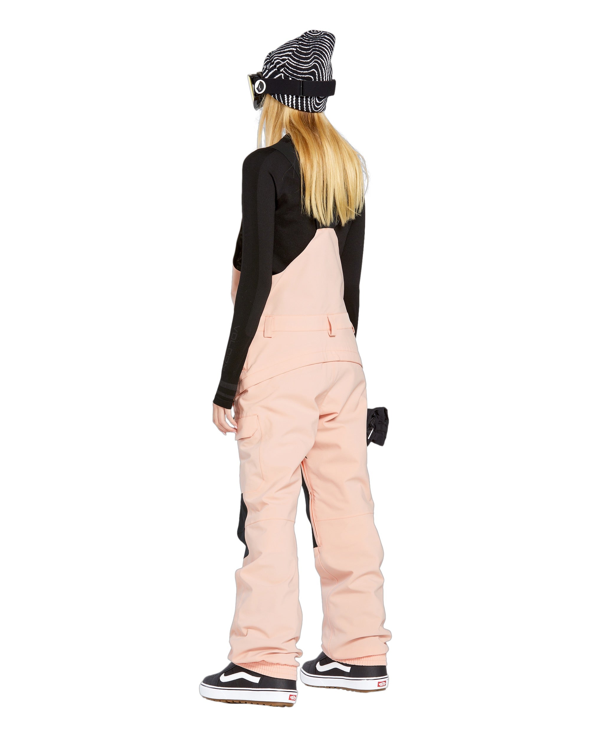 Volcom Women's Creston 3D Stretch Bib Overall - A pair of light pink snow bibs with a black stripe down the side and two front pockets.