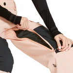 Volcom Women's Creston 3D Stretch Bib Overall - A light pink bib overall with a black logo on the left leg and a zipper running down the front.